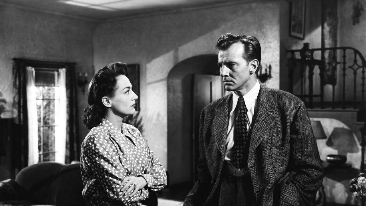 Joan Crawford standing with a man in a tie